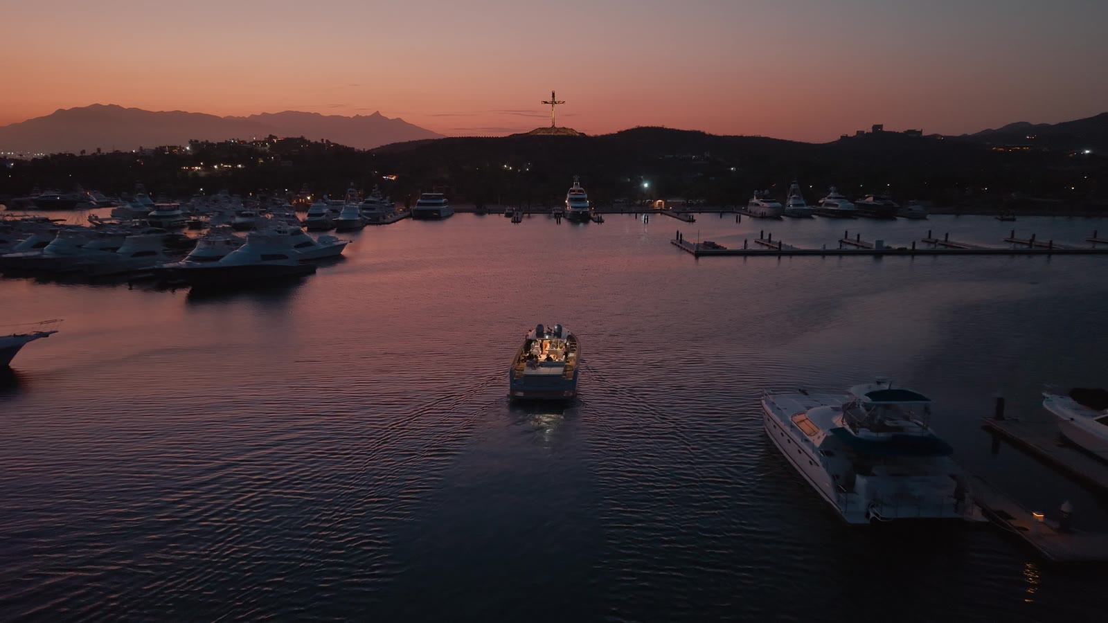 A yacht returning to the marina at sunset