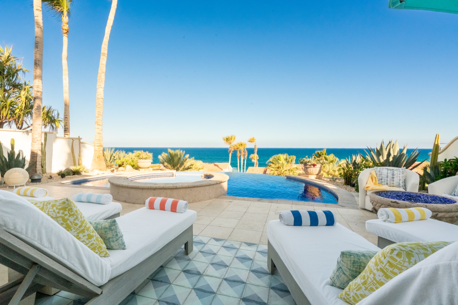 Loungers beside the infinity pool looking out over the sea to the horizon